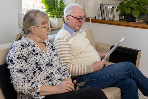 An older couple reading together at home